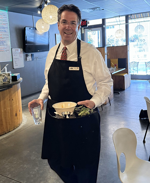 bill holding a tray of food